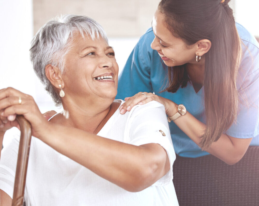 Nurse smiling with a resident.
