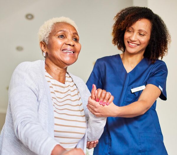 Nurse helping a resident stand.
