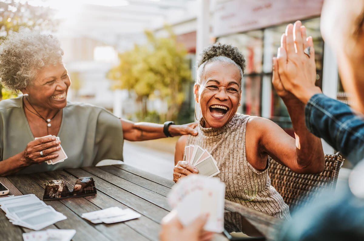 Woman receiving a high-five while playing cards.