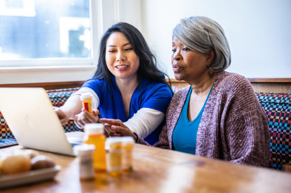 Nurse helping a patient with medication.
