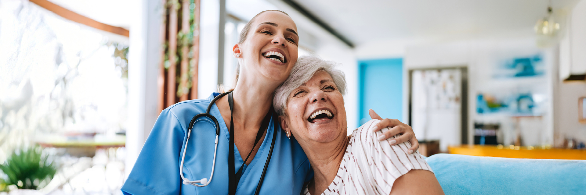 Nurse and resident laughing together.