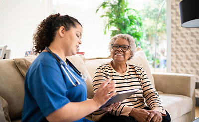 Woman having a conversation with a nurse.
