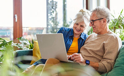 Two people looking at a computer.