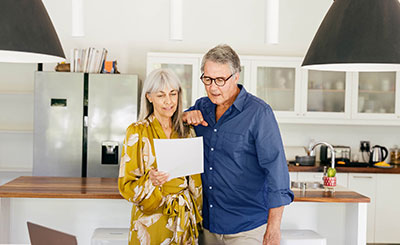 Two people looking at a rates sheet.