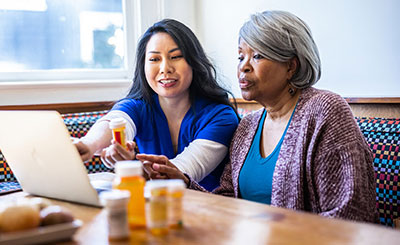 Nurse reviewing a prescription with a patient.