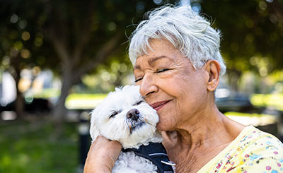 Woman cuddling a dog.
